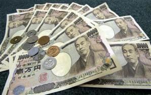 Japanese 10,000 yen bank notes and coins are displayed March 3, 2006. The yen fell on Friday after J..